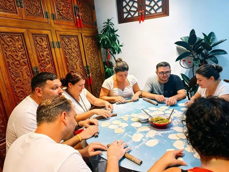Group of travelers enjoying a private dumpling cooking class on a customized Beijing cultural tour