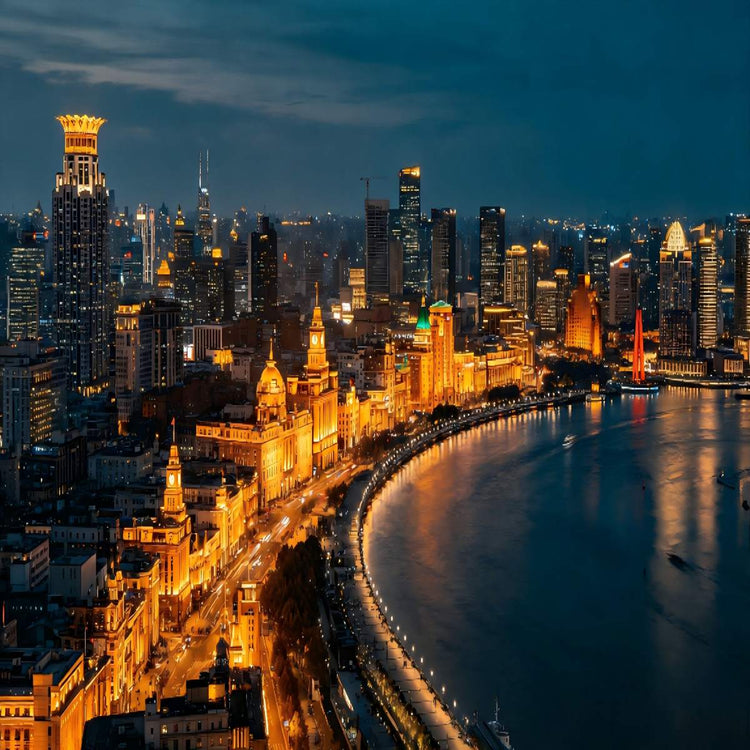 Aerial night overlook of Shanghai Bund historic waterfront buildings alongside Huangpu River for airport layover tour