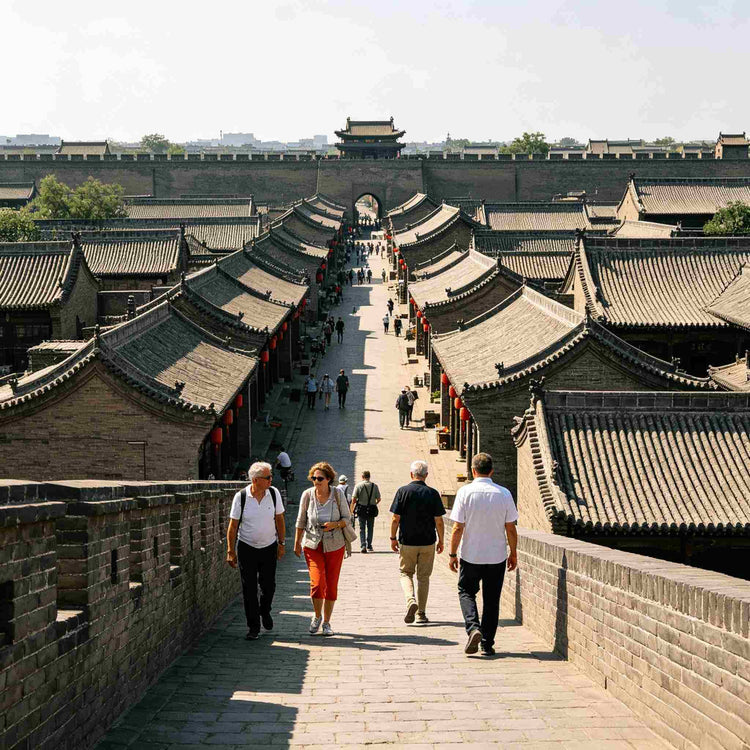 Foreign tourists walking on Pingyao Ancient City Wall overlooking the old town