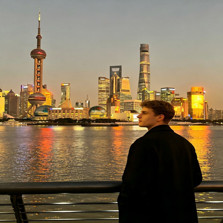 Foreign tourist overlooking Lujiazui skyline from The Bund waterfront during Shanghai private sightseeing