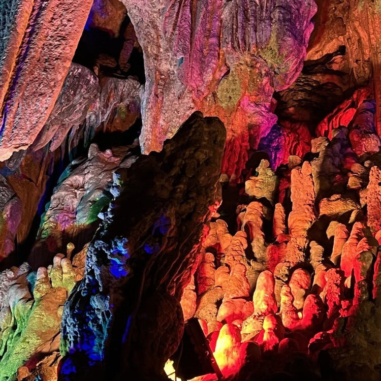 Illuminated limestone cave formations, famous Silver Cave attraction in Yangshuo