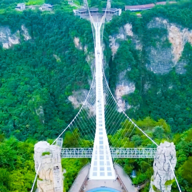 High glass suspension bridge over deep Zhangjiajie canyon
