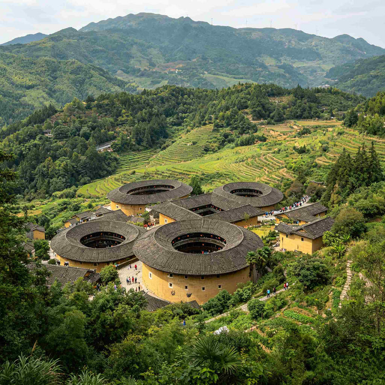 Aerial view of Tianluokeng Tulou Cluster nestled in green mountain valley