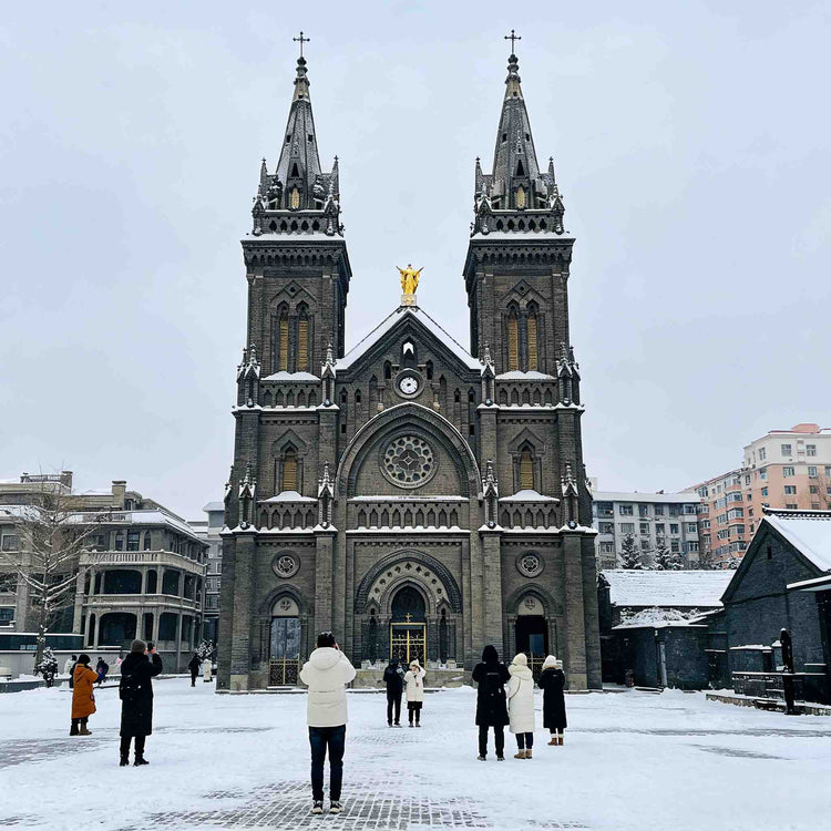 Historic Gothic-style Jilin Catholic Church covered in snow in the city center