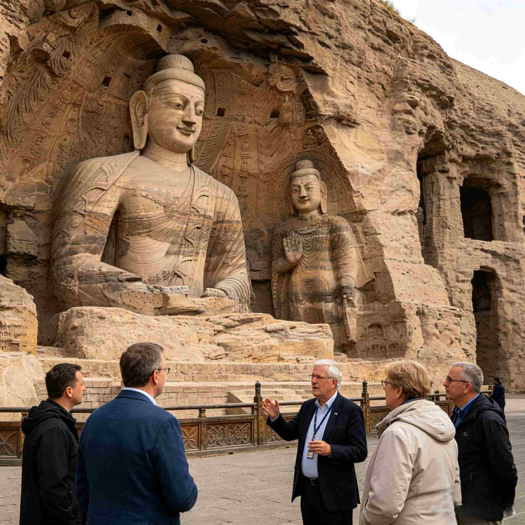 International visitors admiring giant Buddha statues at UNESCO Yungang Grottoes