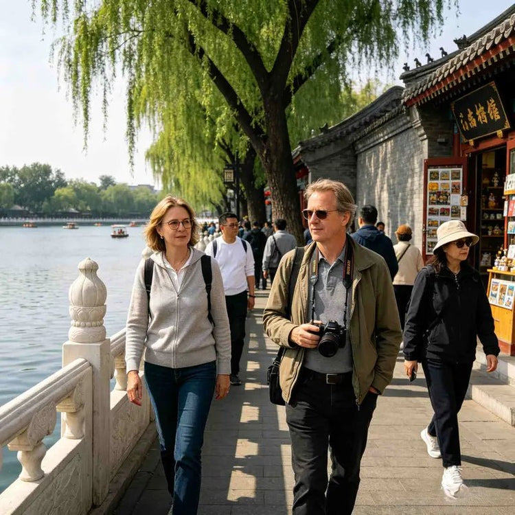 International travelers walking along Houhai Lake in Beijing traditional hutong area