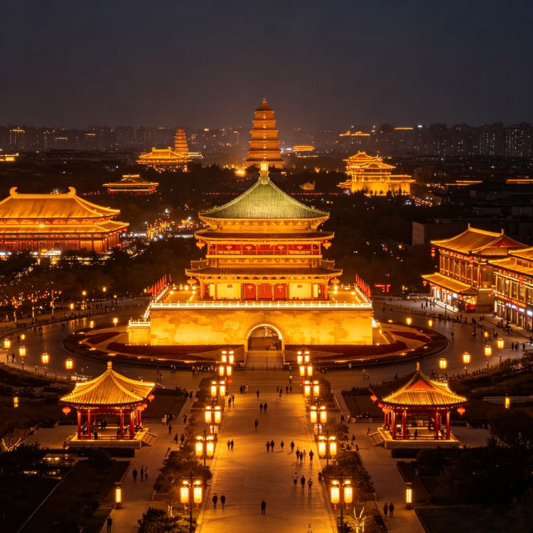 Aerial night view of Great Tang Ever-Bright City and Giant Wild Goose Pagoda, golden lit Tang-style avenue, Xi'an