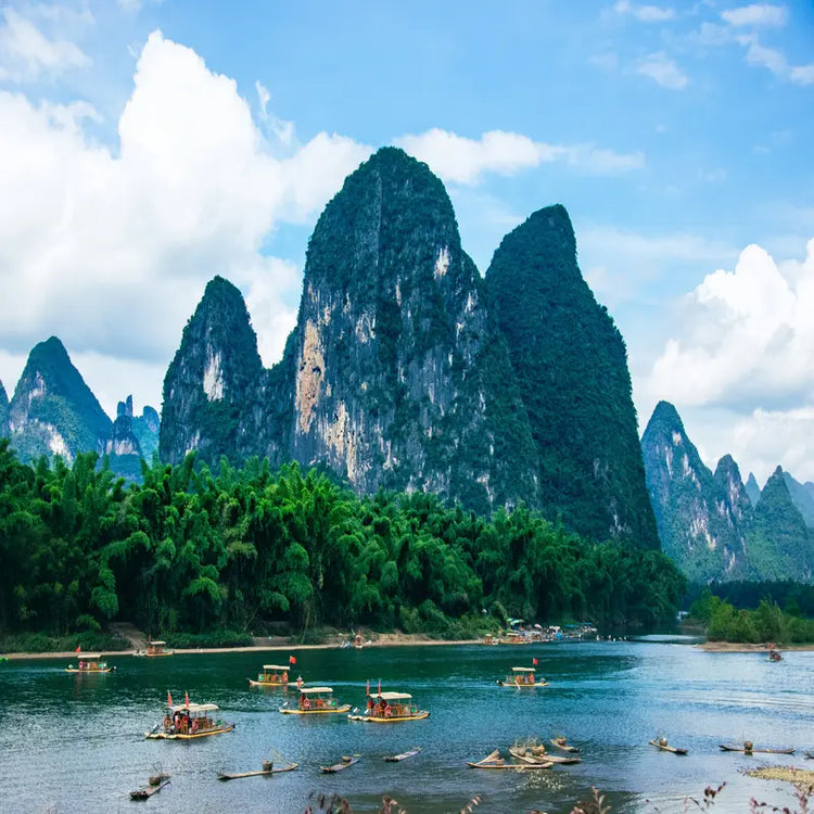 Guilin Li River cruise with bamboo rafts passing iconic karst mountain peaks at Xingping, the landscape on China's 20 RMB banknote, Guangxi China