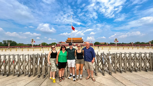 Travelers at Tiananmen Square Beijing with national flag, safe China travel