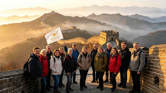 First-time international visitors on Great Wall of China at sunrise, Yajoon Travel tour group flag