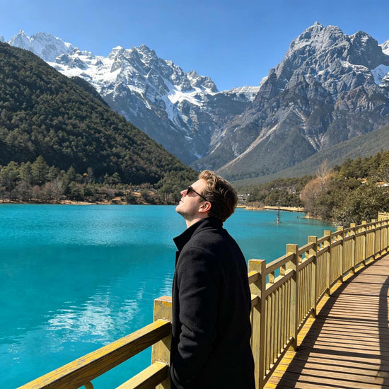 Foreign tourist enjoying the view of Jade Dragon Snow Mountain and Blue Moon Valley near Lijiang.