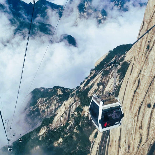Cable car running beside steep Huashan rock cliffs