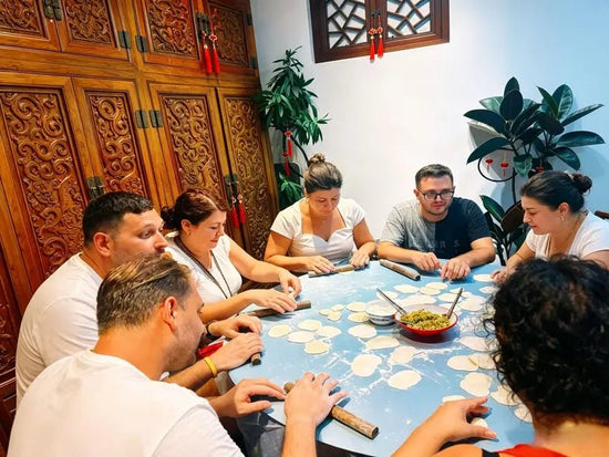 Group of travelers enjoying a private dumpling cooking class on a customized Beijing cultural tour