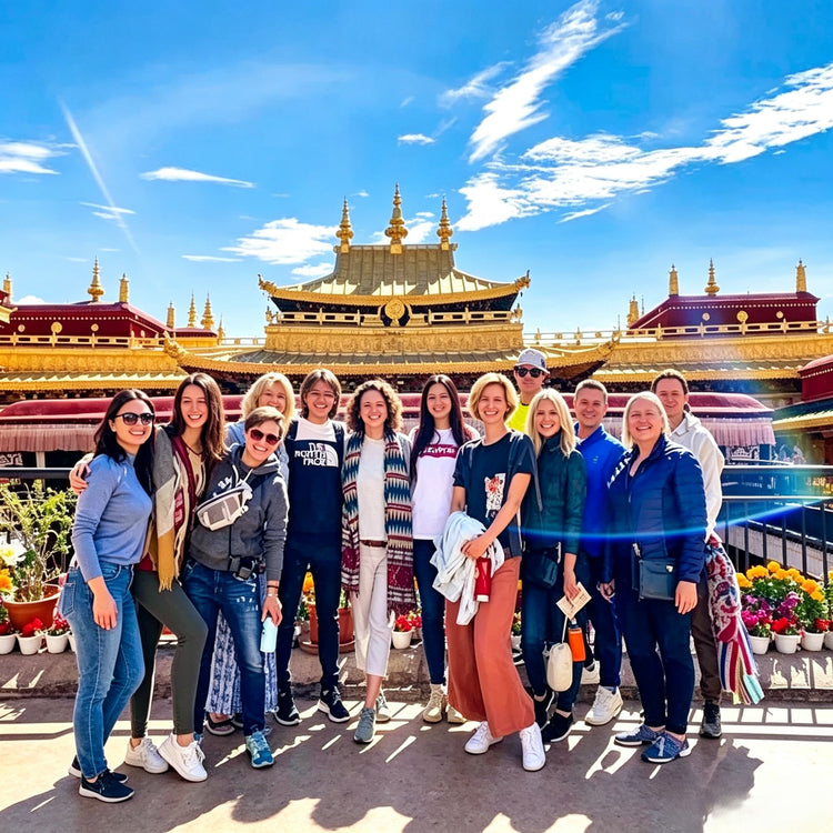 Group of foreign tourists posing in front of Jokhang Temple golden roof in Lhasa