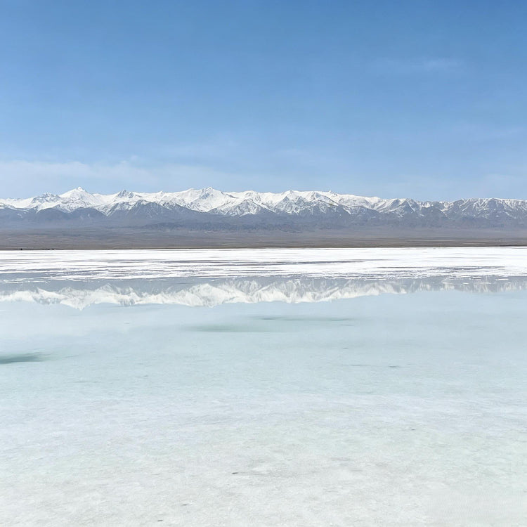 Chaka Salt Lake sky mirror scenery with calm water and snow-capped mountains