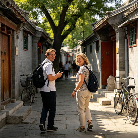Two western tourists walking through authentic Beijing hutong alley, old neighborhood private walking tour