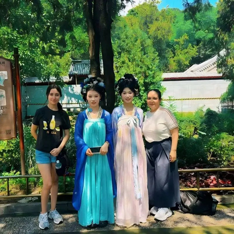Tourists posing with women in traditional Hanfu dresses at the Summer Palace in Beijing on a private China tour