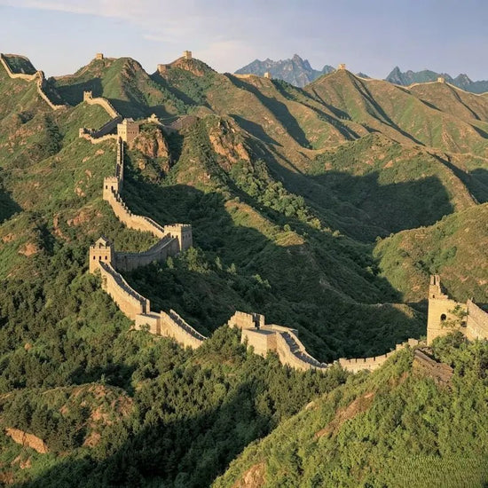 Aerial view of the Badaling Great Wall winding along green mountain ridges with watchtowers near Beijing