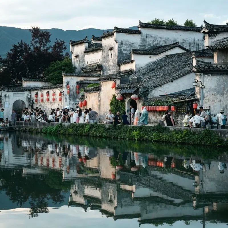 Hongcun Ancient Village Anhui, traditional Huizhou-style horse-head gable architecture, South Lake water reflection, historic Chinese ink-wash village, China inbound travel attraction