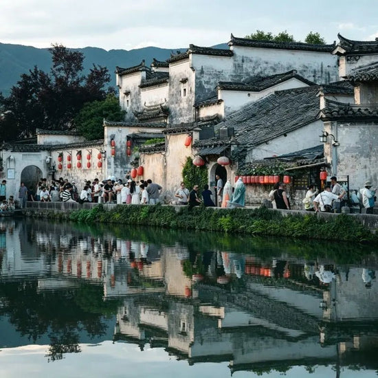 Hongcun Ancient Village Anhui, traditional Huizhou-style horse-head gable architecture, South Lake water reflection, historic Chinese ink-wash village, China inbound travel attraction