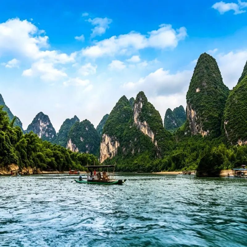 Li River cruise Guilin with karst mountain peaks and traditional Chinese boat, Guangxi China
