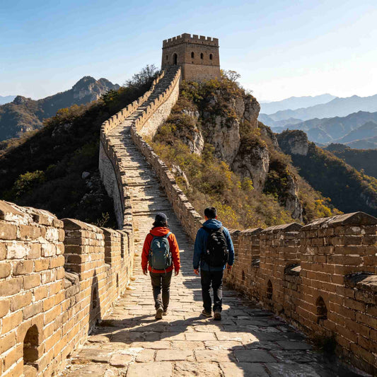 Two hikers walking on authentic Simatai Great Wall section with original ancient stone wall