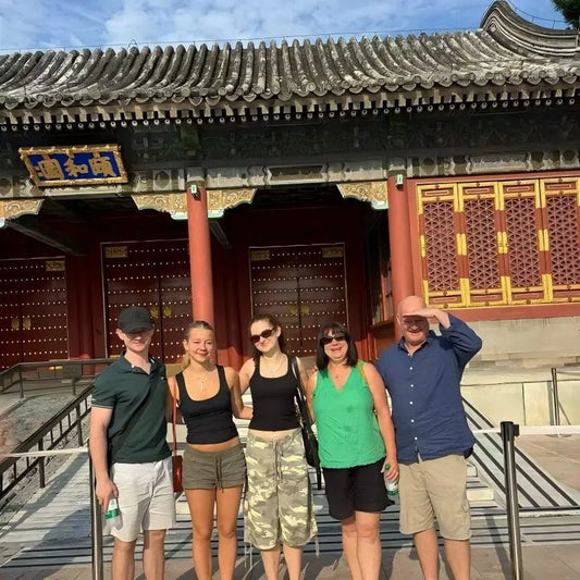 Family of five standing in front of the Summer Palace entrance gate in Beijing on a private China tour