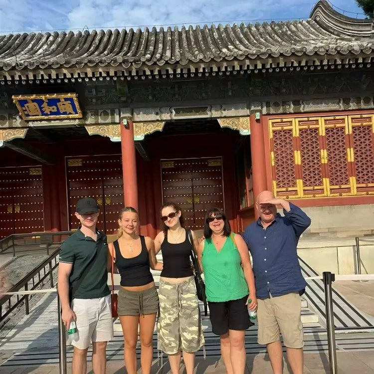 Family of five standing in front of the Summer Palace entrance gate in Beijing on a private China tour