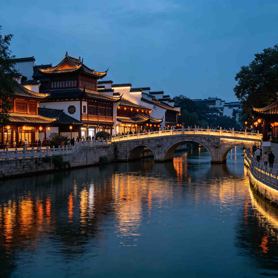 Scenic Qinhuai River at dusk with illuminated traditional architecture, Nanjing Fuzimiao waterfront evening view