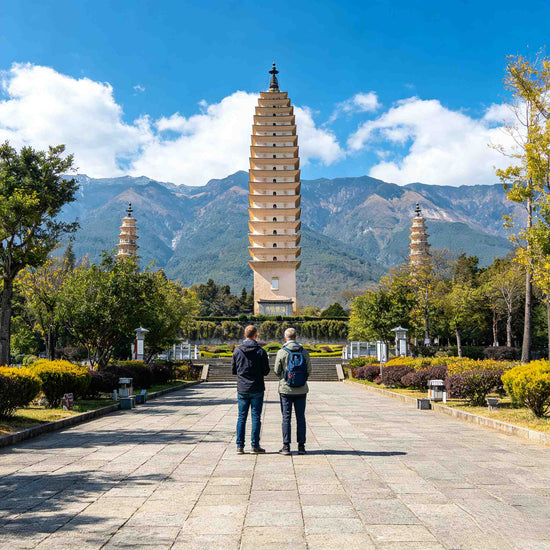 Foreign tourists cycling along Erhai Lake in Dali, Yunnan, with Cangshan Mountain in the background.