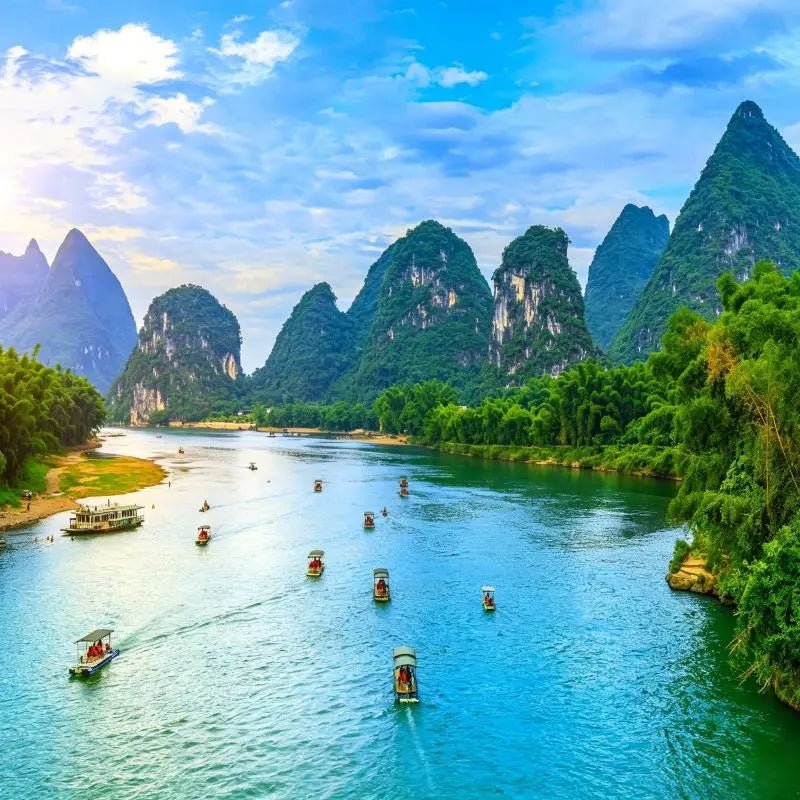 Li River karst peak forest landscape in Guilin Guangxi China, iconic natural landmark with limestone mountains, turquoise river, bamboo boats and blue sky