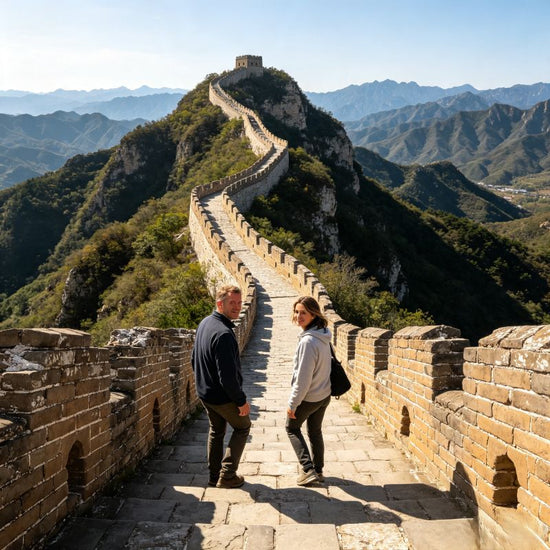 Two tourists hiking on original Simatai Great Wall, daytime mountain scenery