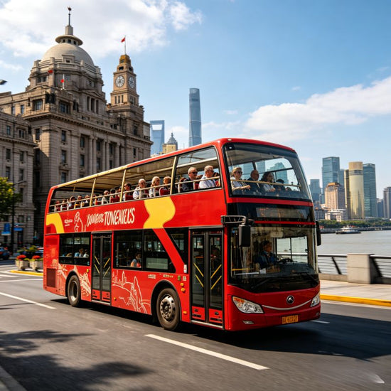 Red double-decker sightseeing bus on Shanghai street, Bund historic buildings in background