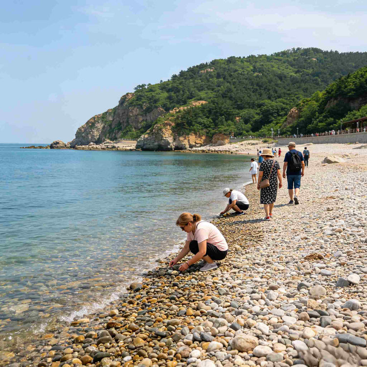 Foreign tourists relaxing on pebble beach of Bangchui Island Scenic Area, Dalian
