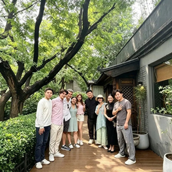 Group photo of guests and team outside Queen's Courtyard tea house in Beijing hutong garden