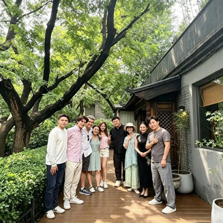 Group photo of guests and team outside Queen's Courtyard tea house in Beijing hutong garden