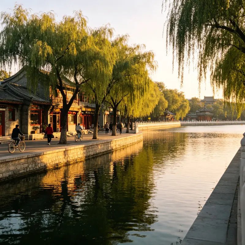 Peaceful morning view of Shichahai lake with willow trees and traditional courtyard architecture, Beijing hutong area
