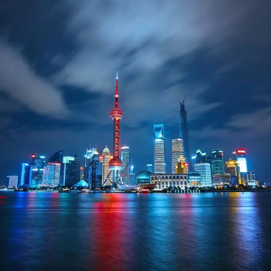 The Bund at night, Pudong skyline and Oriental Pearl Tower across Huangpu River, Shanghai, China