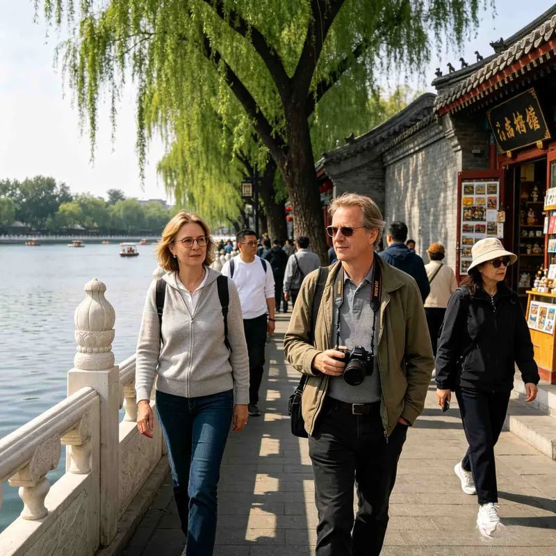 International travelers walking along Houhai Lake in Beijing traditional hutong area