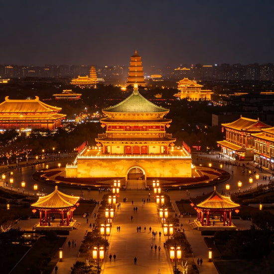 Aerial night view of Great Tang Ever-Bright City and Giant Wild Goose Pagoda, golden lit Tang-style avenue, Xi'an