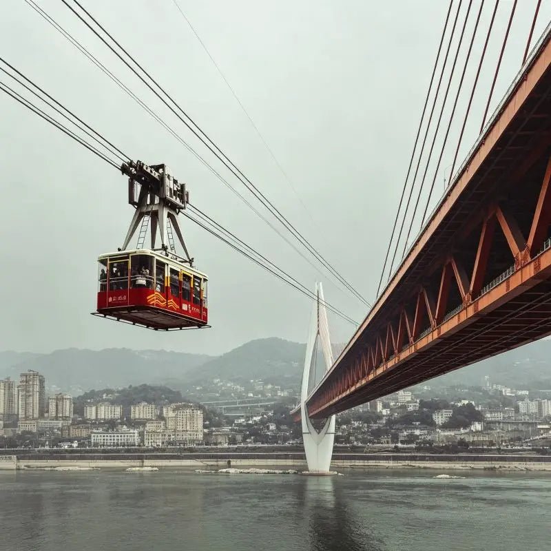 Yangtze River Cableway Chongqing, cable car crossing Yangtze River with city bridge and mountain skyline, China inbound travel attraction