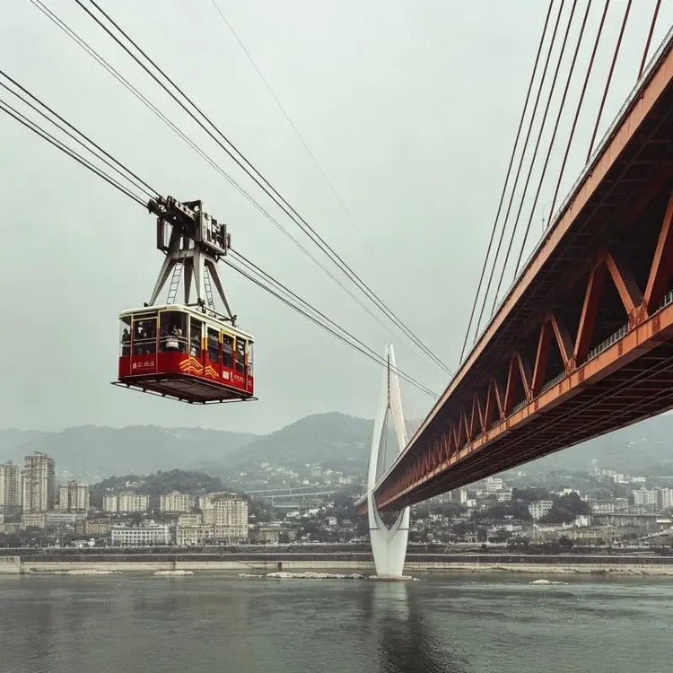 Yangtze River Cableway Chongqing, cable car crossing Yangtze River with city bridge and mountain skyline, China inbound travel attraction