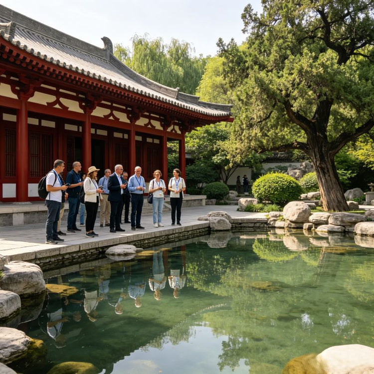 Huaqing Palace imperial garden with tranquil lake, ancient cypress trees and red Tang-style palaces, group of visitors sightseeing, Xi'an China