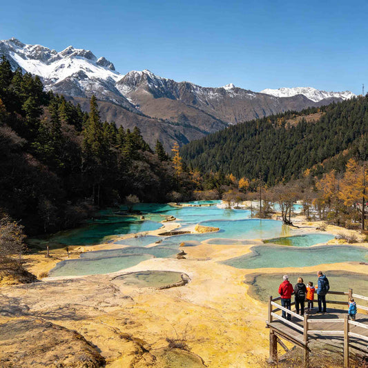Panoramic view of Multi-Colored Pond with snow mountain range in Huanglong Scenic Area