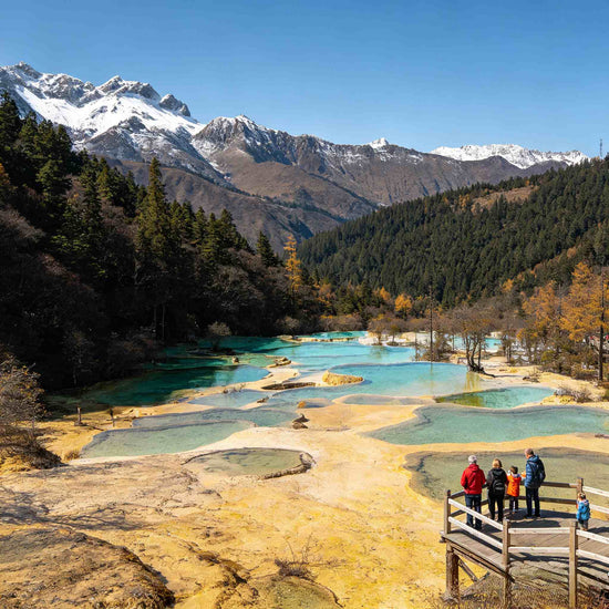 Panoramic view of Multi-Colored Pond with snow mountain range in Huanglong Scenic Area
