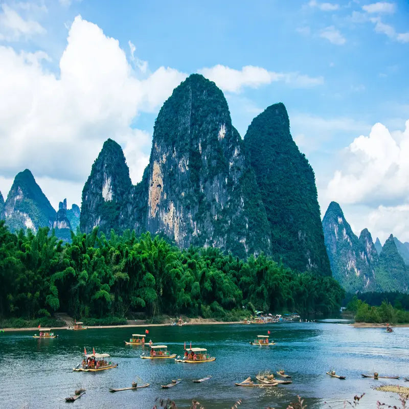 Guilin Li River cruise with bamboo rafts passing iconic karst mountain peaks at Xingping, the landscape on China's 20 RMB banknote, Guangxi China
